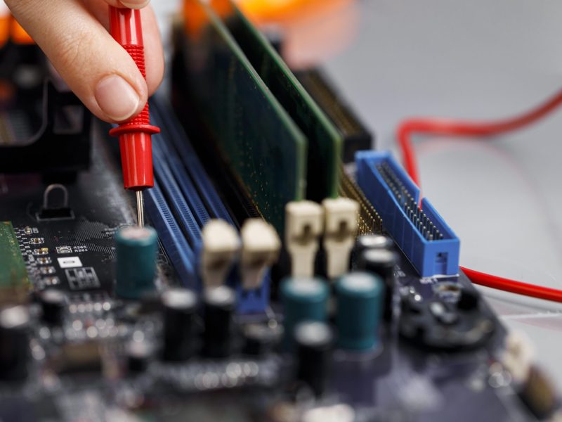 female-technician-with-computer-motherboard